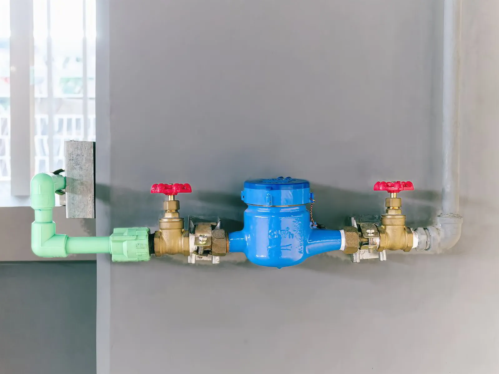 TK Plumbing technician inspecting backflow preventer on residential water meter in Sarasota