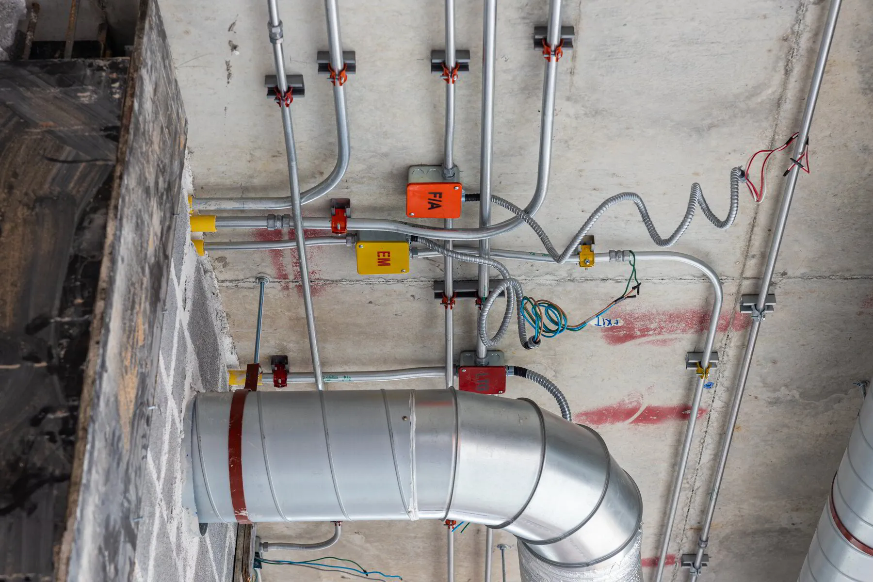 TK Plumbing technician inspecting commercial pipe system in Sarasota business