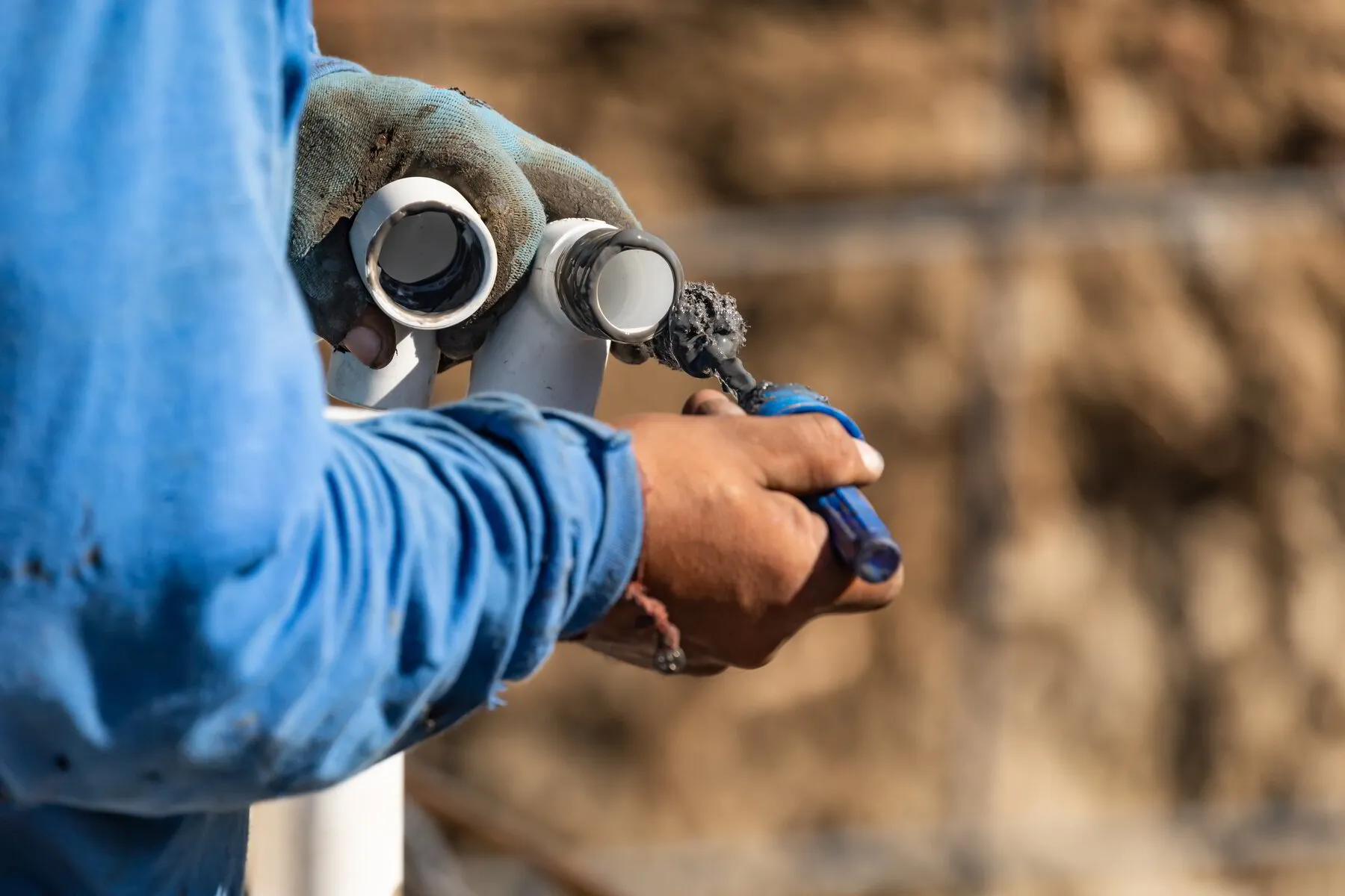 TK Plumbing technician fitting sewer pipes with cement in Sarasota FL