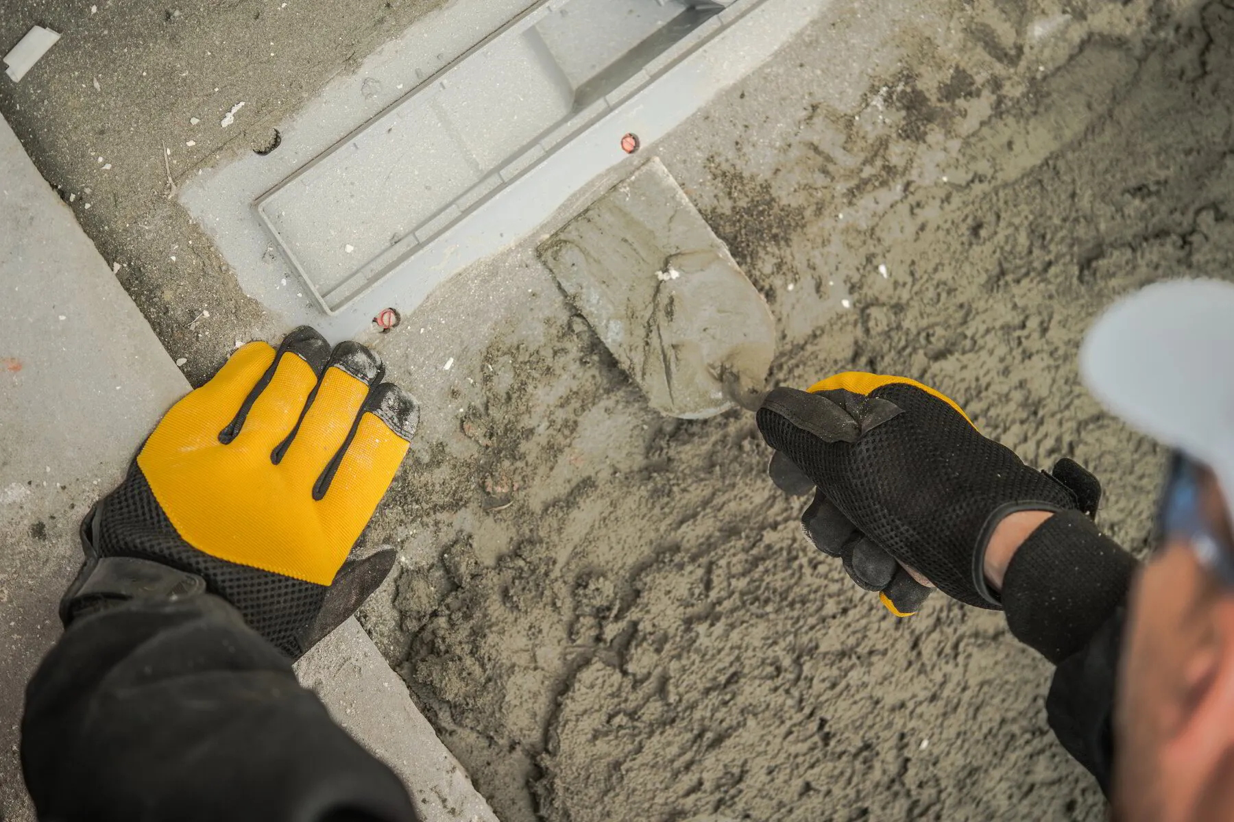 TK Plumbing technician finishing concrete after slab leak repair in Sarasota Florida